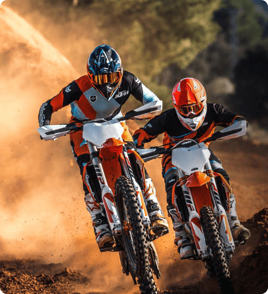 Motocross riders jumping through dusty terrain